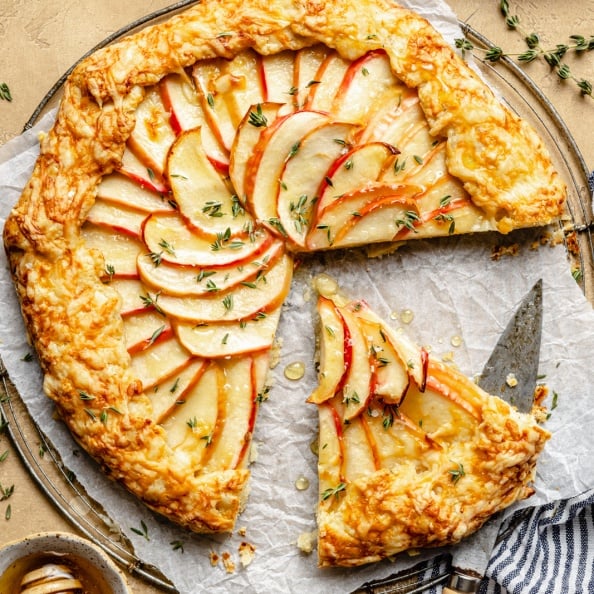 apple cheddar galette sliced on a wire rack