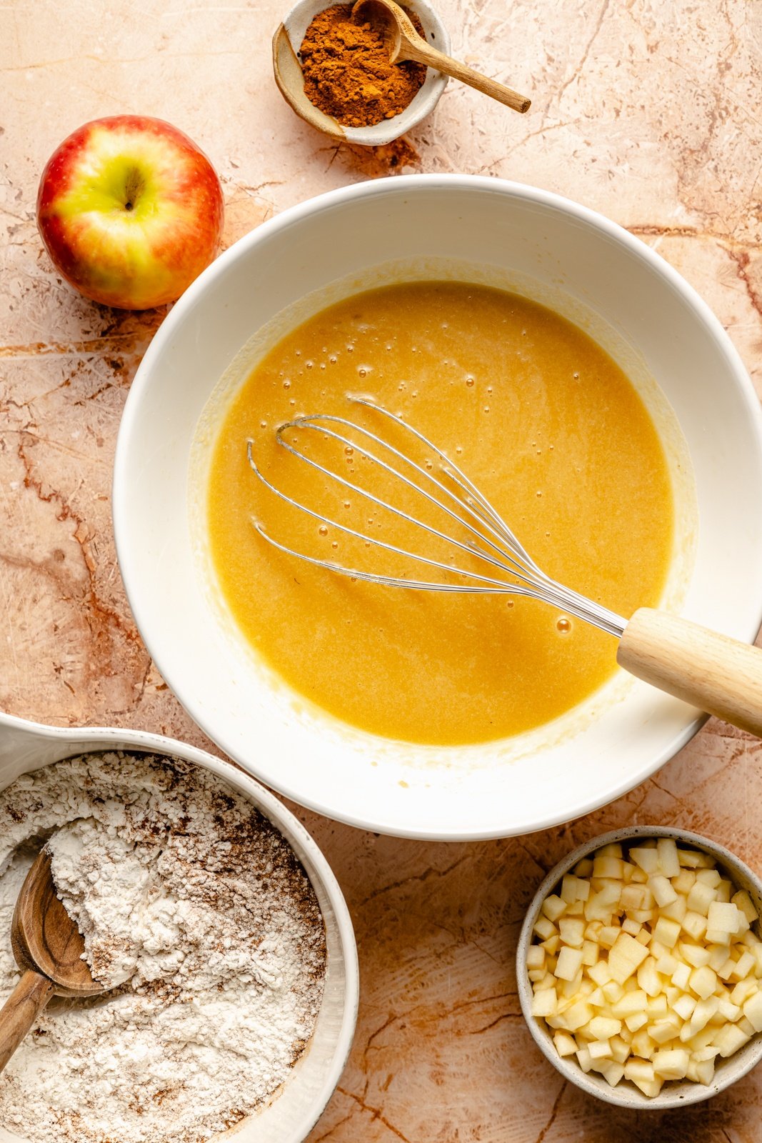 mixing batter for an apple cake