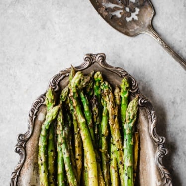 sesame garlic roasted asparagus on a silver platter