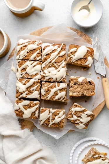 apple coffee cake sliced on parchment paper