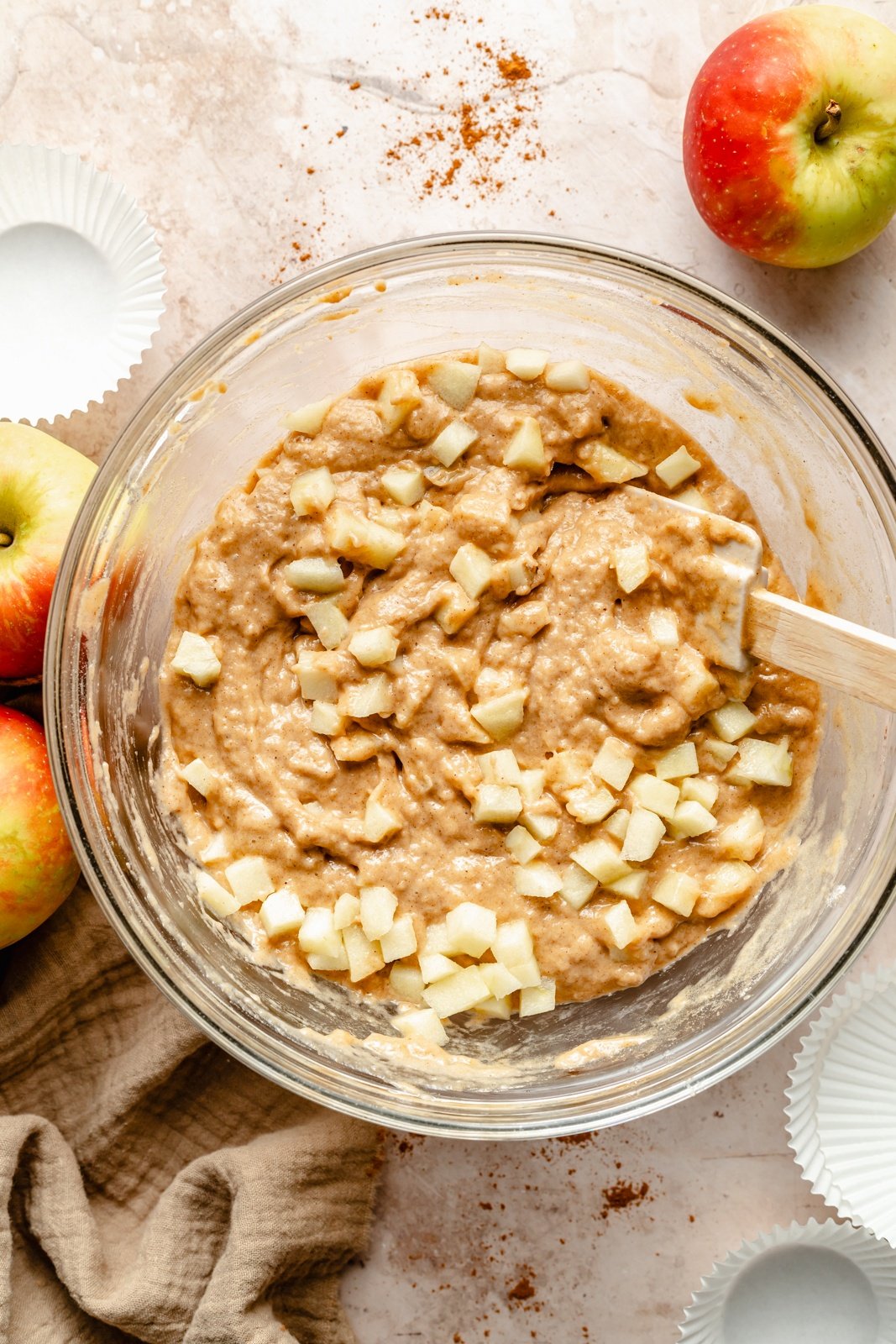 mixing batter for an apple muffins recipe