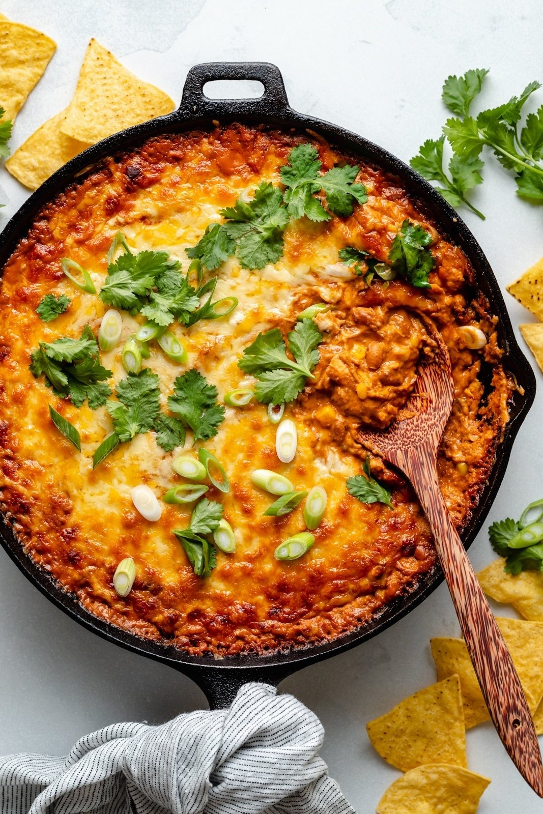 chicken enchilada dip in a skillet with a spoon