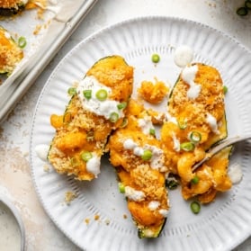 buffalo mac and cheese stuffed zucchini on a plate