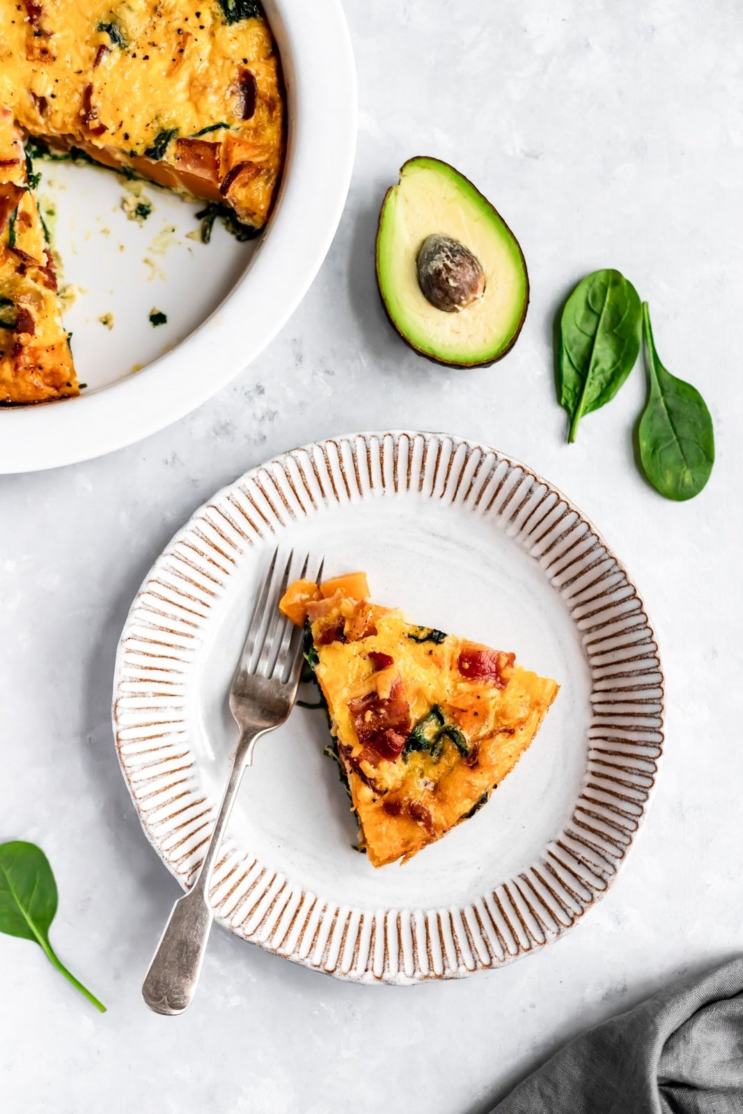 slice of butternut squash bacon spinach quiche on a plate