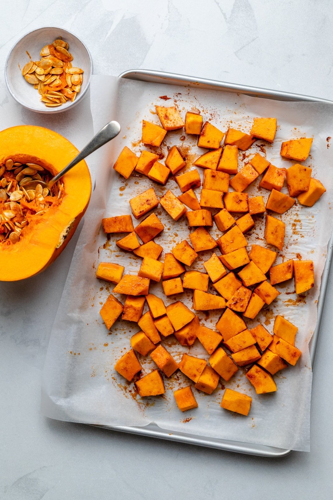 cubed pumpkin on a baking sheet