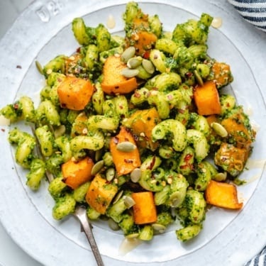 cilantro pesto pasta with roasted pumpkin on a plate