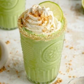 key lime pie smoothie in glass topped with whipped cream