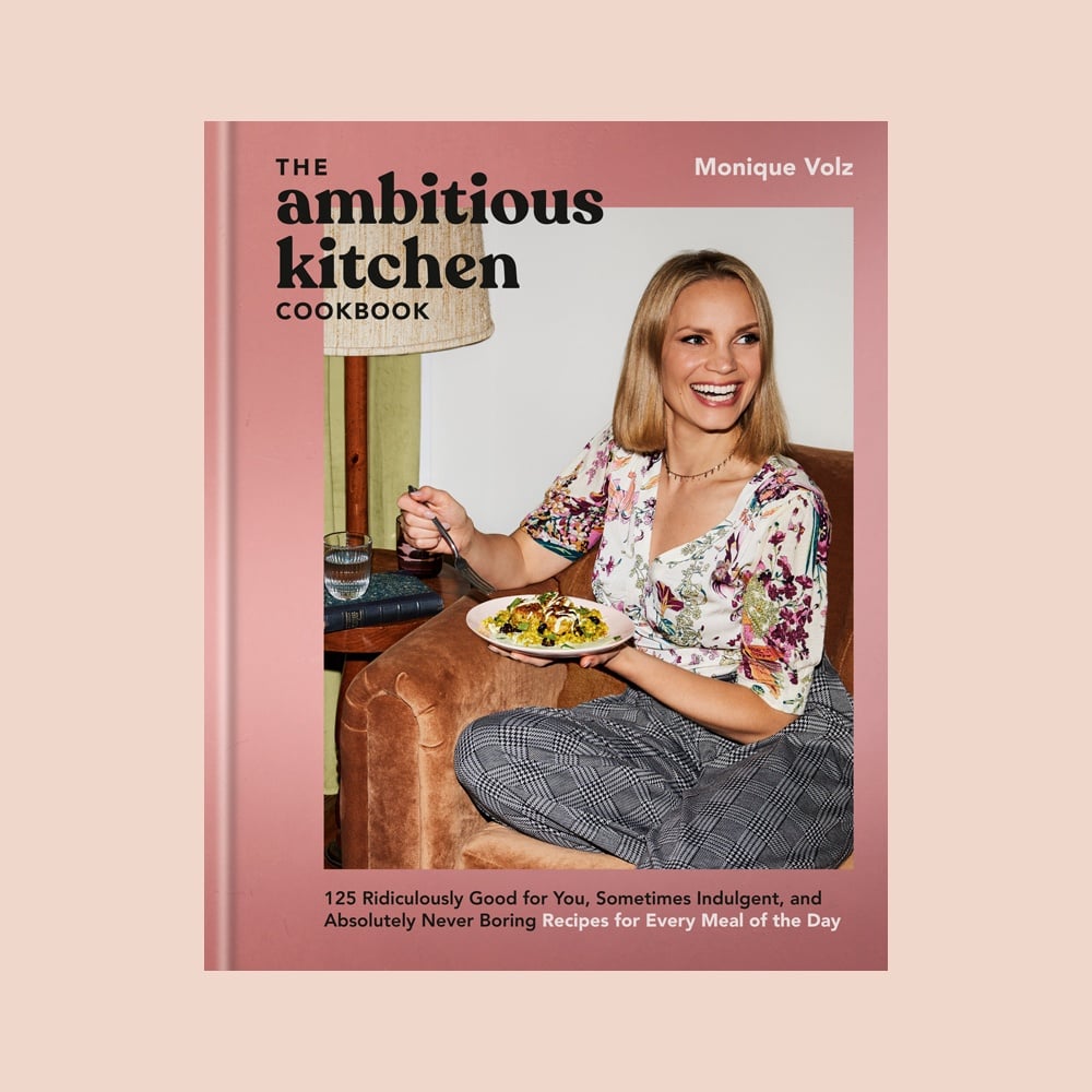 the cover of the ambitious kitchen cookbook on a pink background