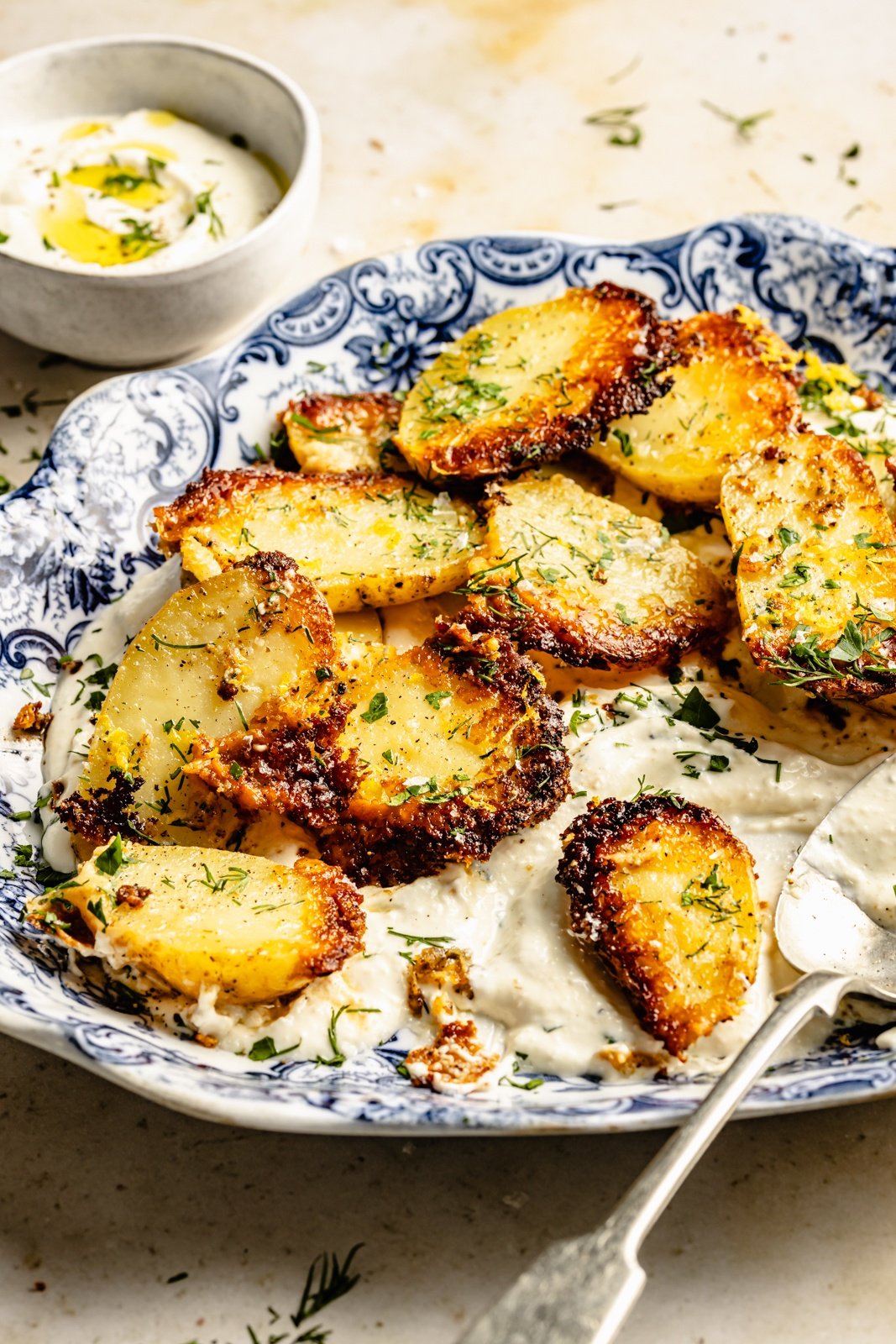 parmesan roasted potatoes on top of whipped feta dip in a bowl