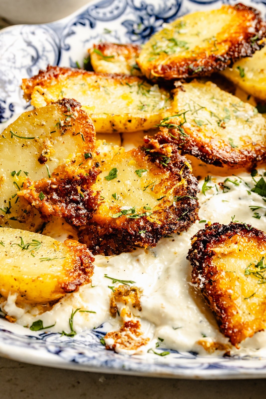 parmesan potatoes in a bowl with garlic feta dip