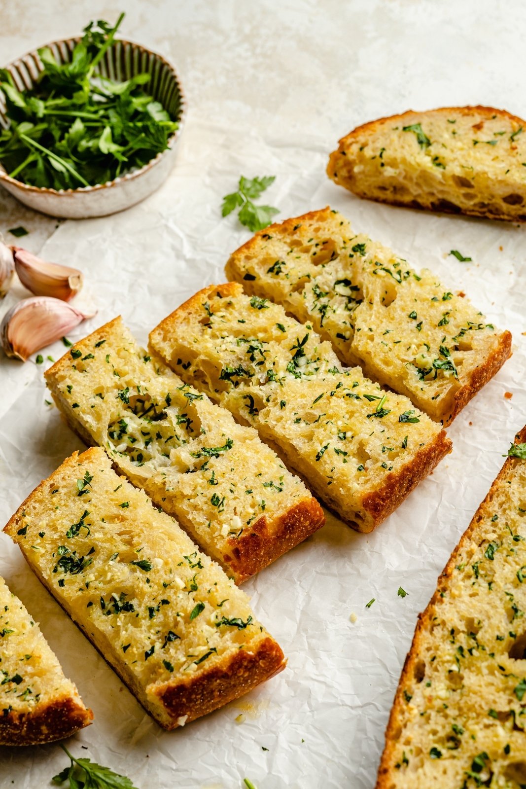 easy garlic bread sliced on parchment paper