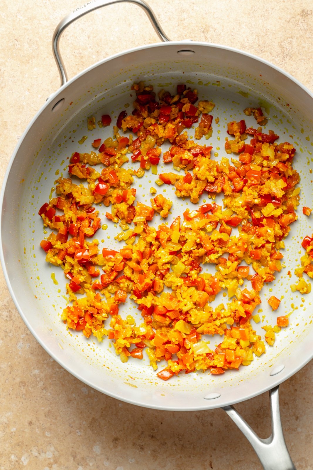 cookking vegetables in a pan to make turmeric rice