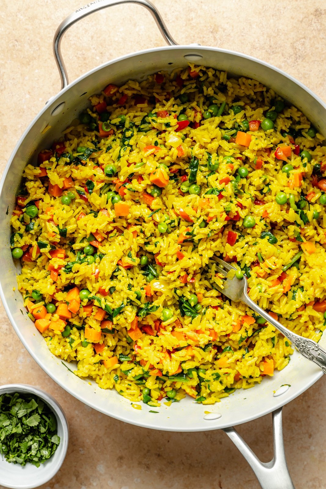 garlic turmeric rice in a pan with vegetables