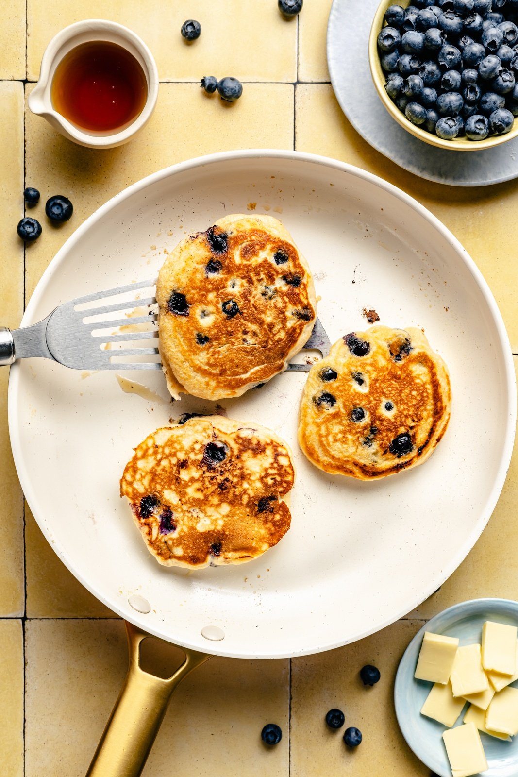 cooking blueberry buttermilk pancakes in a skillet