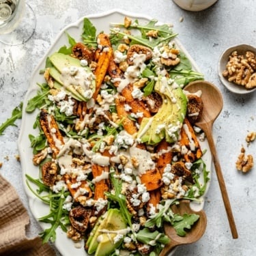 carrot arugula salad with avocado on a platter