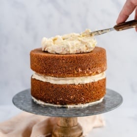 frosting a cake with vanilla buttercream