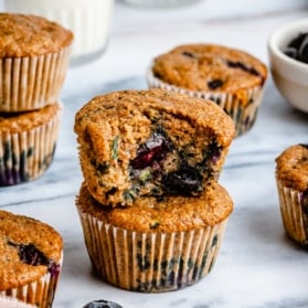 two blueberry zucchini muffins in a stack