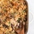 healthy tuna noodle casserole in a pan with a wooden spoon