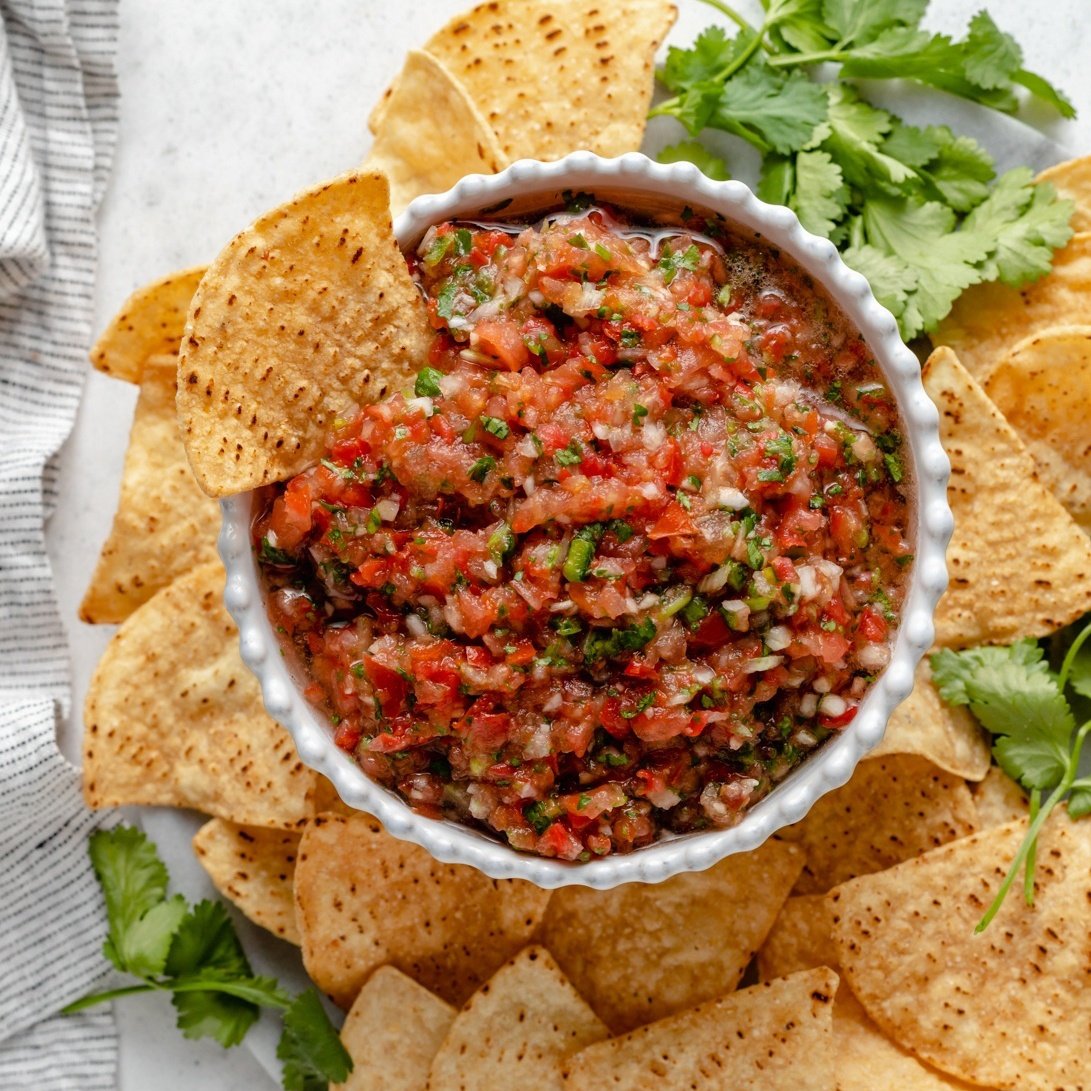 homemade salsa in a bowl next to tortilla chips