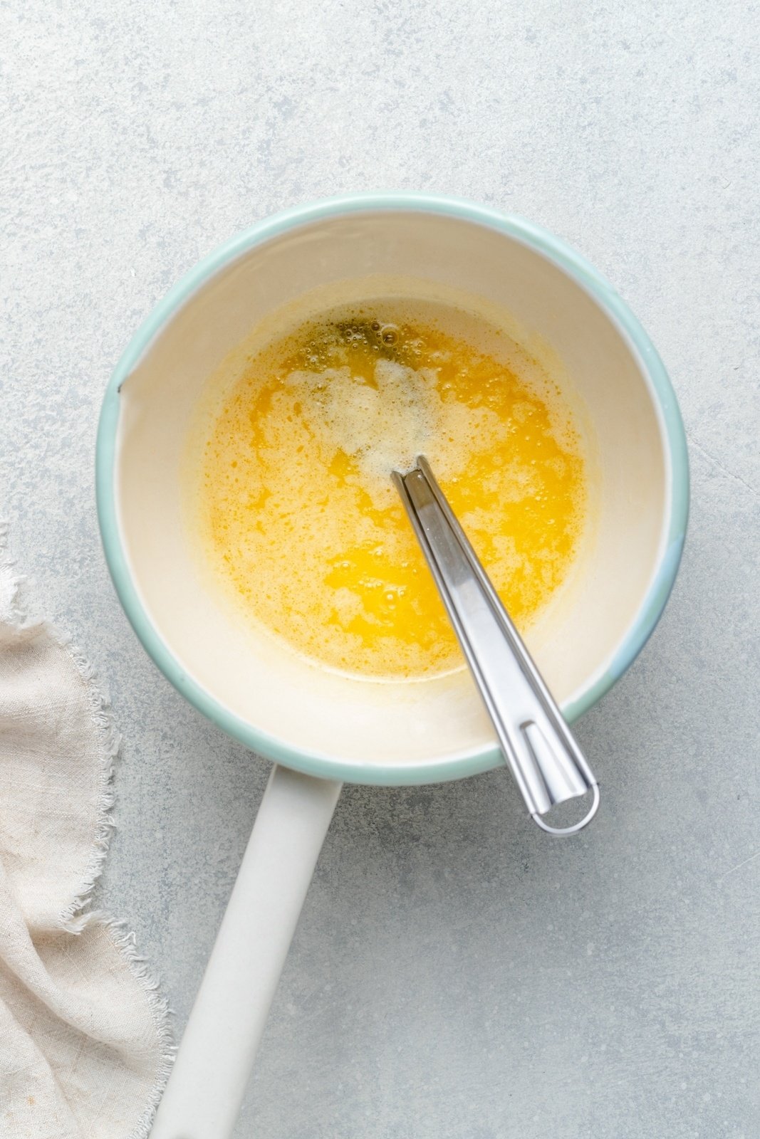 whisking butter in a sauce pan to make brown butter