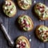 avocado crostini with feta and pomegranate seeds