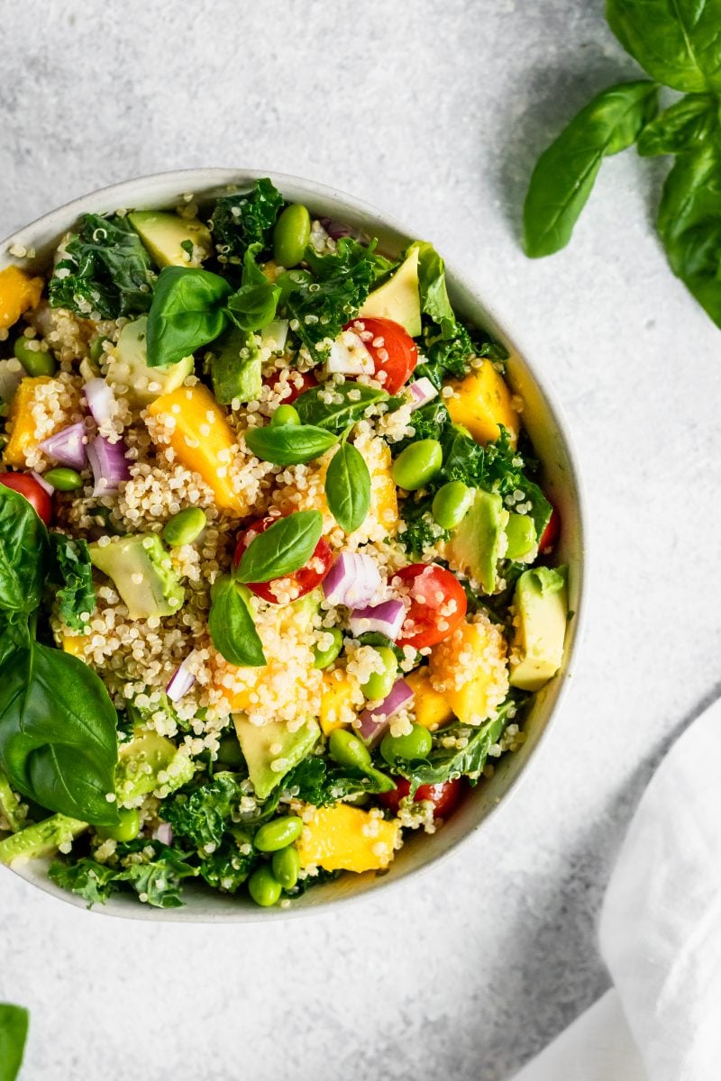 Kale quinoa salad with mango and edamame in a bowl