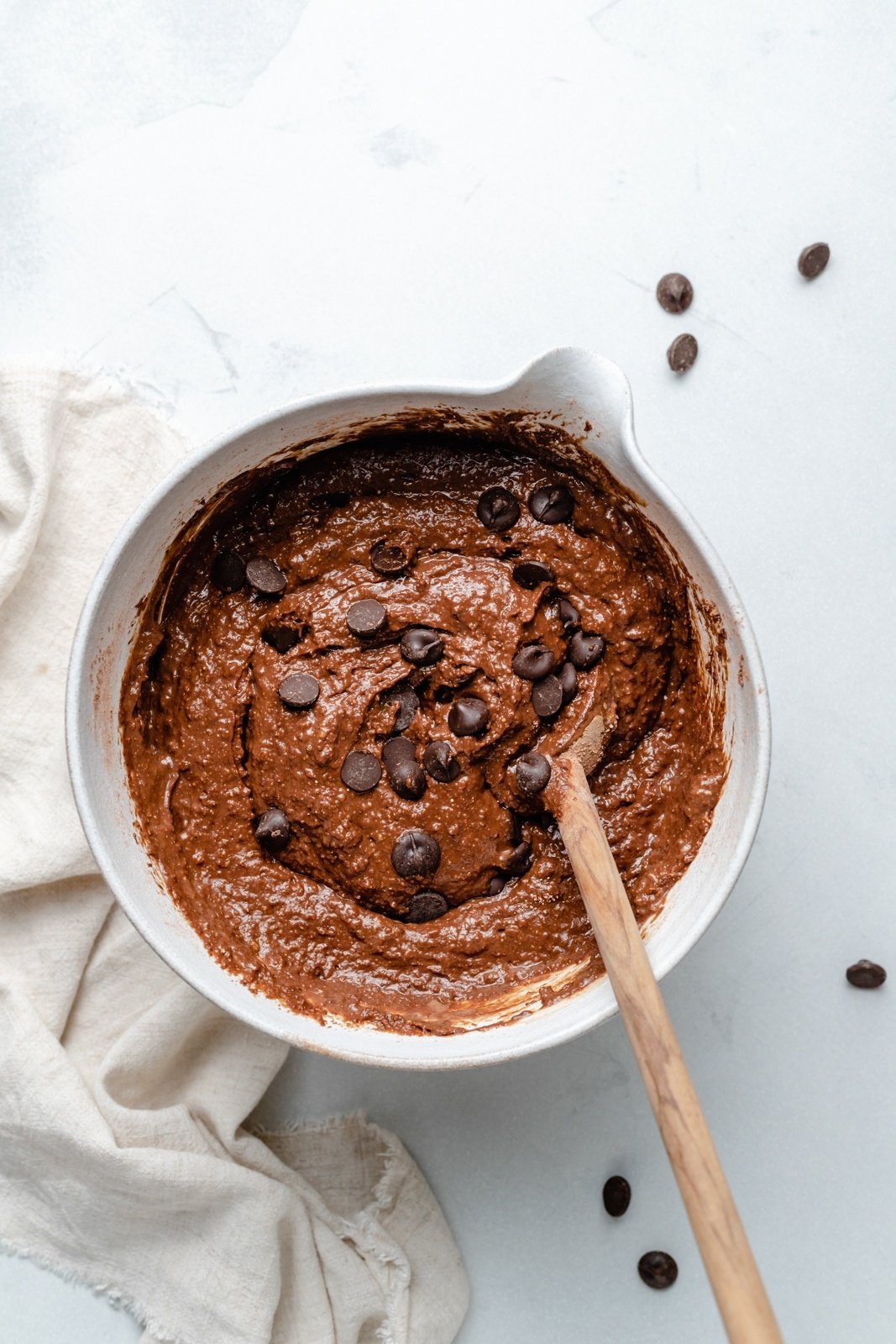 mixing batter for chocolate almond butter pumpkin muffins