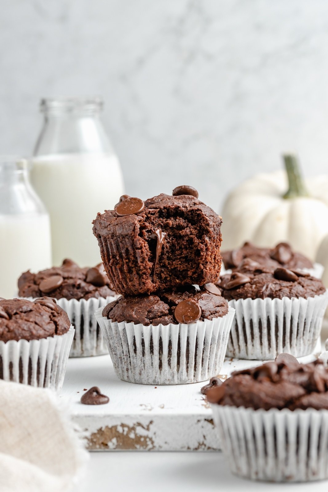 two almond butter chocolate pumpkin muffins stacked