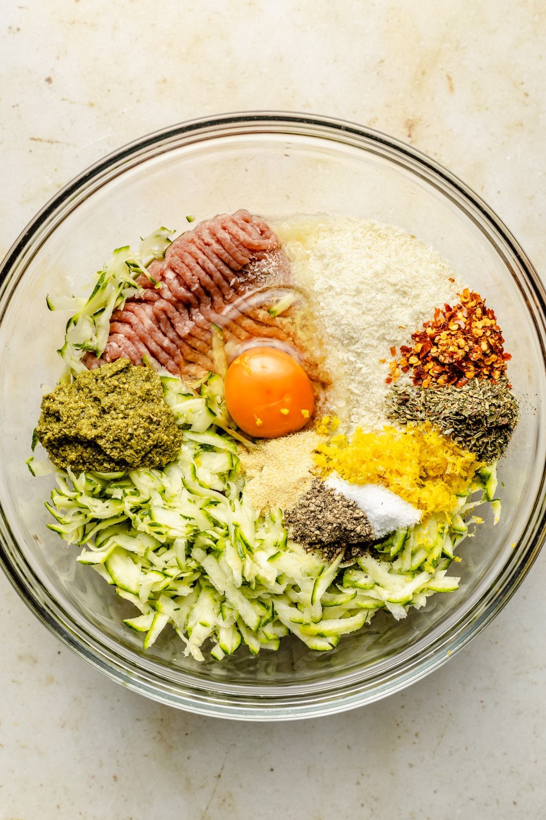 ingredients for pesto chicken meatballs in a bowl