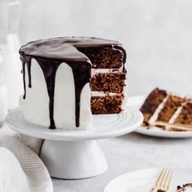 Gluten Free and Grain Free Tahini Chocolate Chip Cookie Cake that tastes like an ice cream cookie sandwich in cake form! Hints of caramel, vanilla and chocolate flavor baked into every single bite then topped with a fluffy very vanilla buttercream.