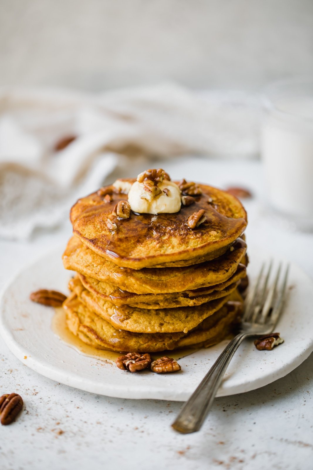 healthy pumpkin oatmeal pancakes on a plate with a fork