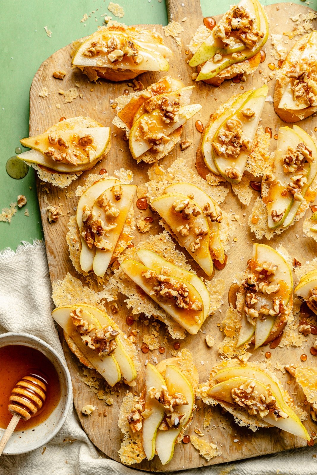 parmesan crusted pear crostini on a serving board