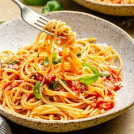 pulling pasta pomodoro out of a bowl with a fork