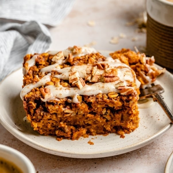 slice of pumpkin baked oatmeal with glaze on a plate