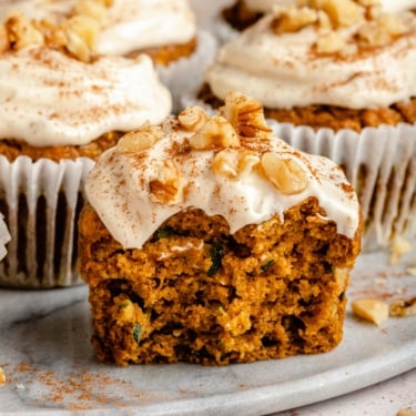 pumpkin zucchini muffin on a plate with a bite taken out