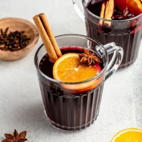 homemade mulled wine in a glass with an orange slice and cinnamon stick