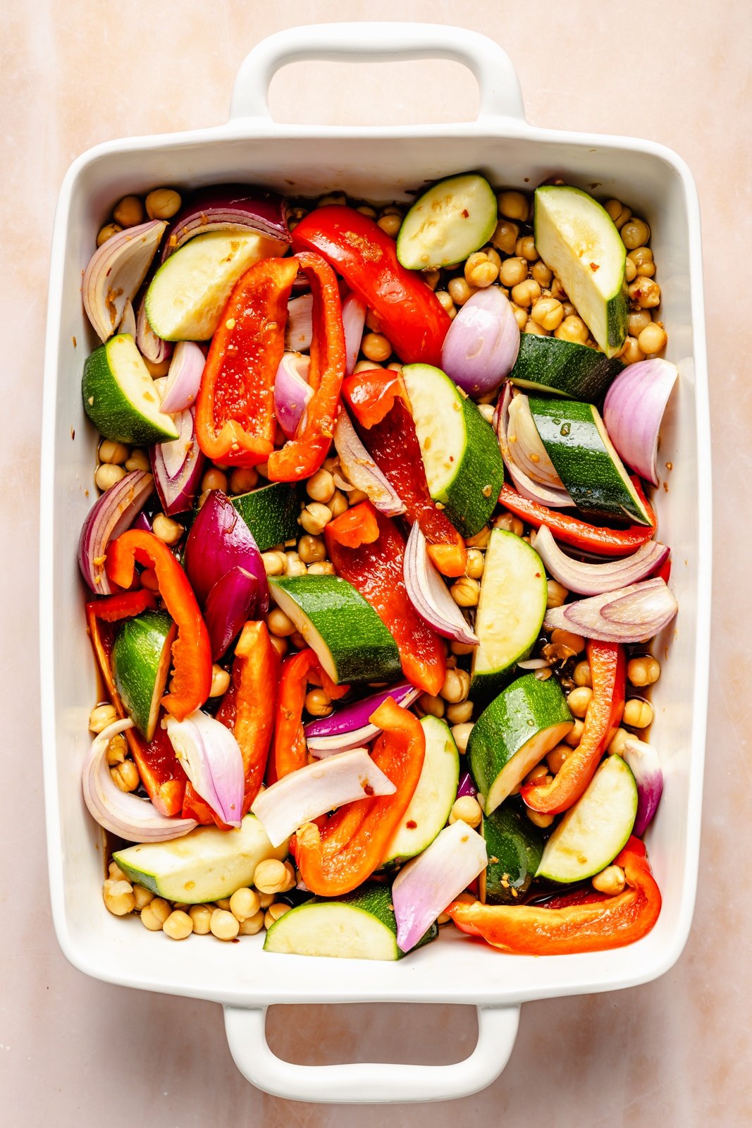 vegetables and chickpeas in a pan before roasting