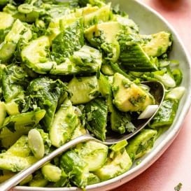 avocado cucumber salad in a bowl with a spoon