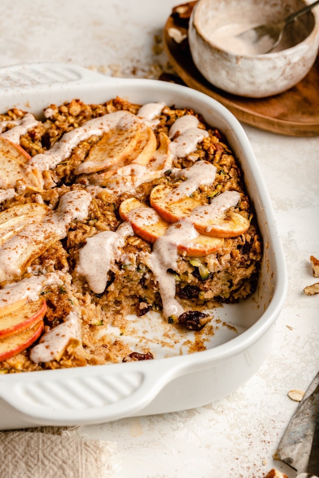 apple zucchini baked oatmeal in a pan with a slice cut out