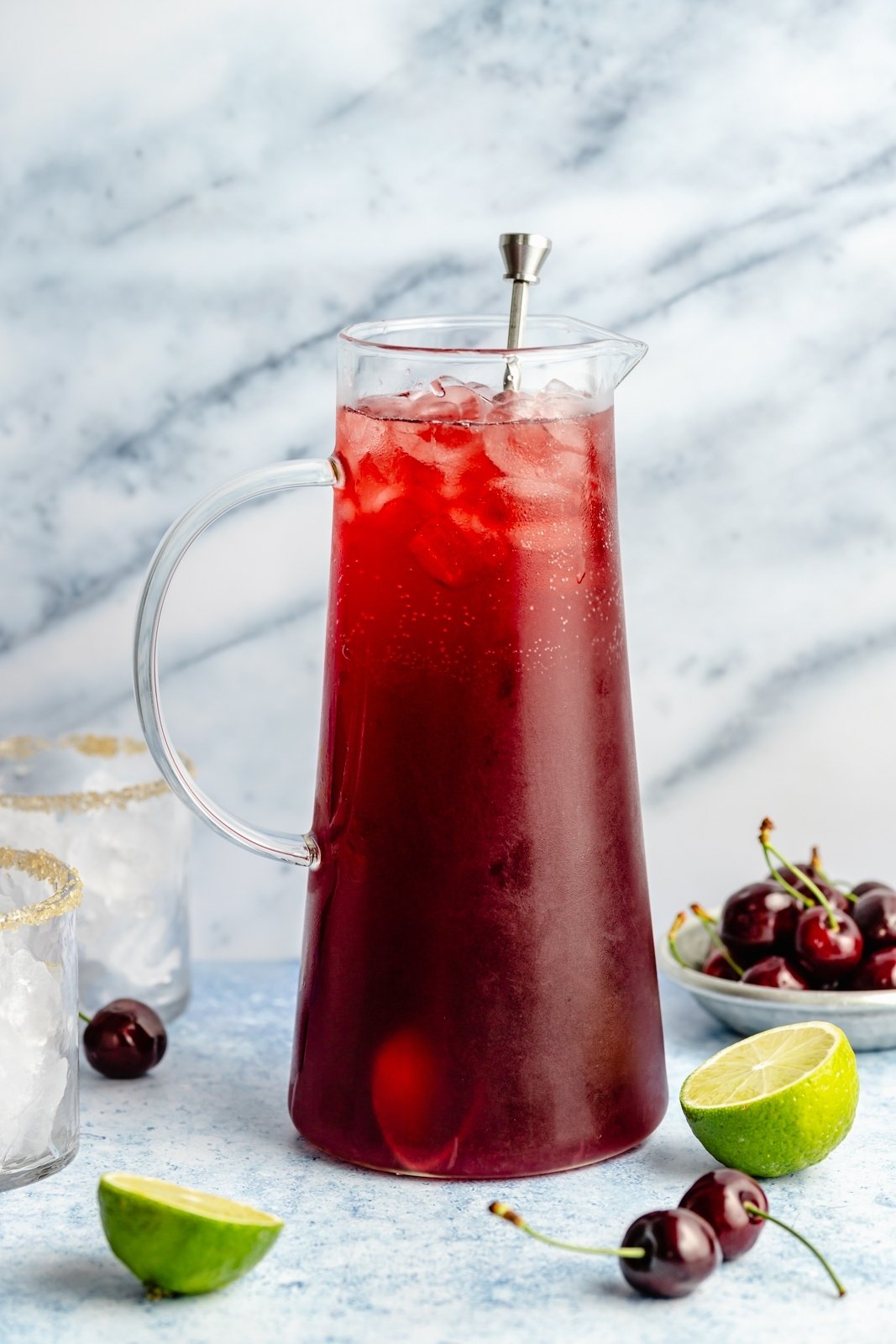 cherry limeade cocktail in a pitcher