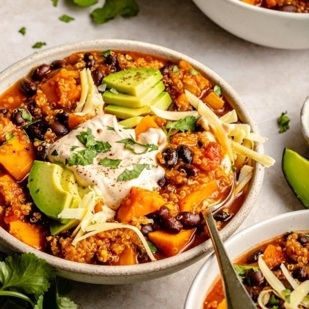 sweet potato black bean chili with toppings in a bowl