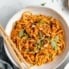 hot chili chicken noodles in a bowl with chopsticks