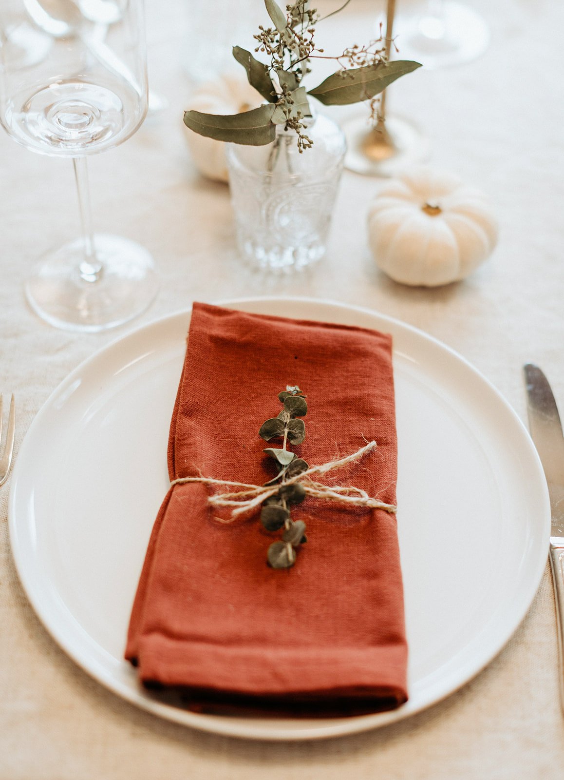 place setting with an orange napkin