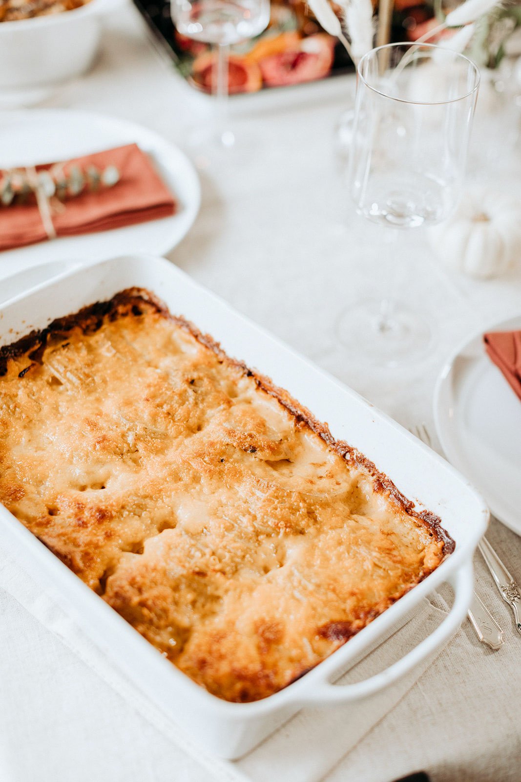 au gratin potatoes in a serving dish on a thanksgiving table