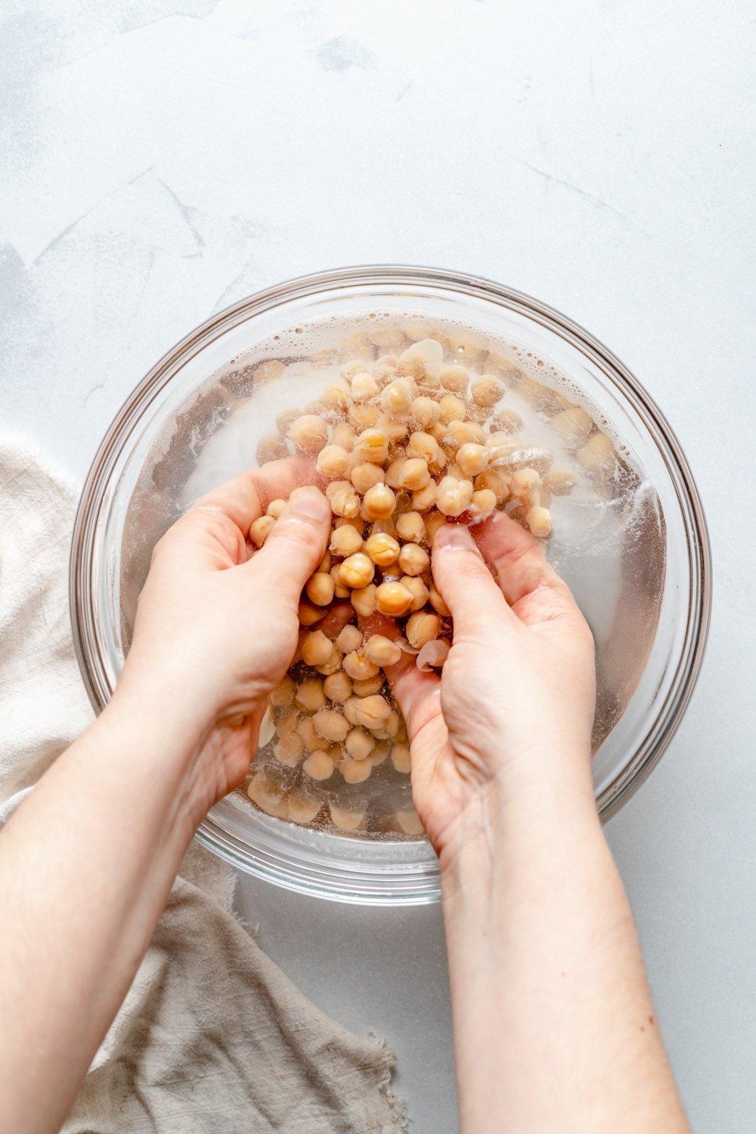 removing the skin from chickpeas to make roasted garlic hummus