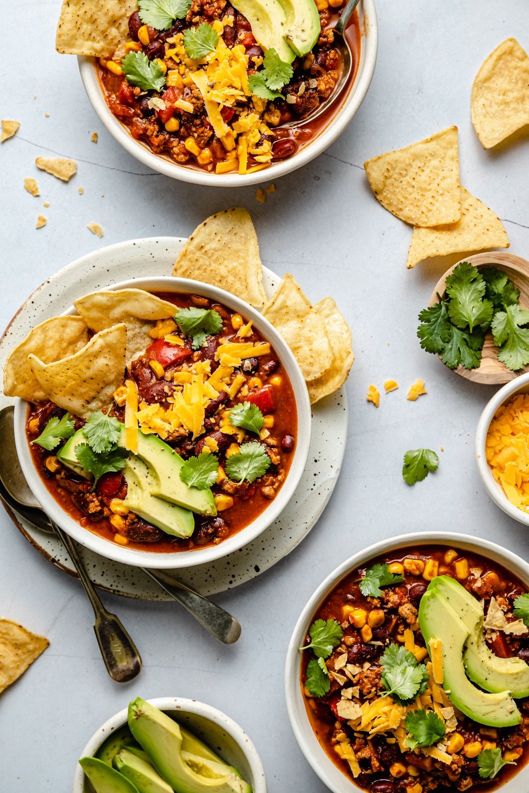 healthy turkey chili with toppings in 3 bowls