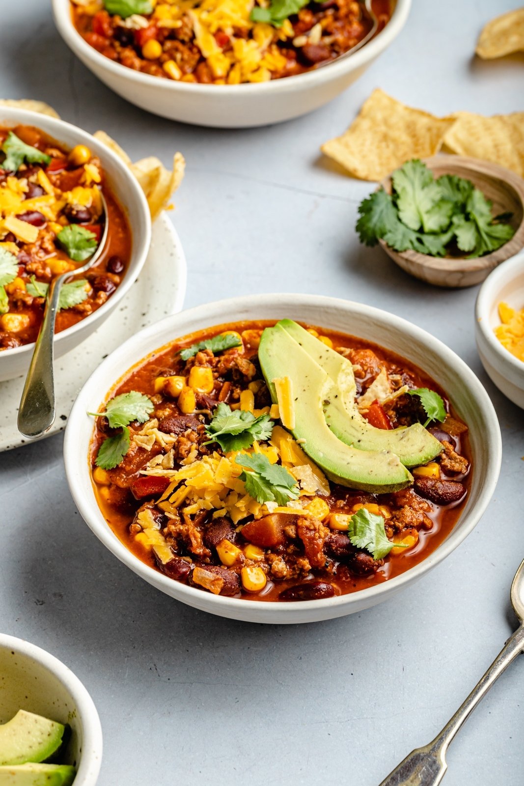 the best turkey chili in a bowl with avocado