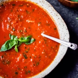 Homemade roasted tomato basil soup in a bowl with a spoon