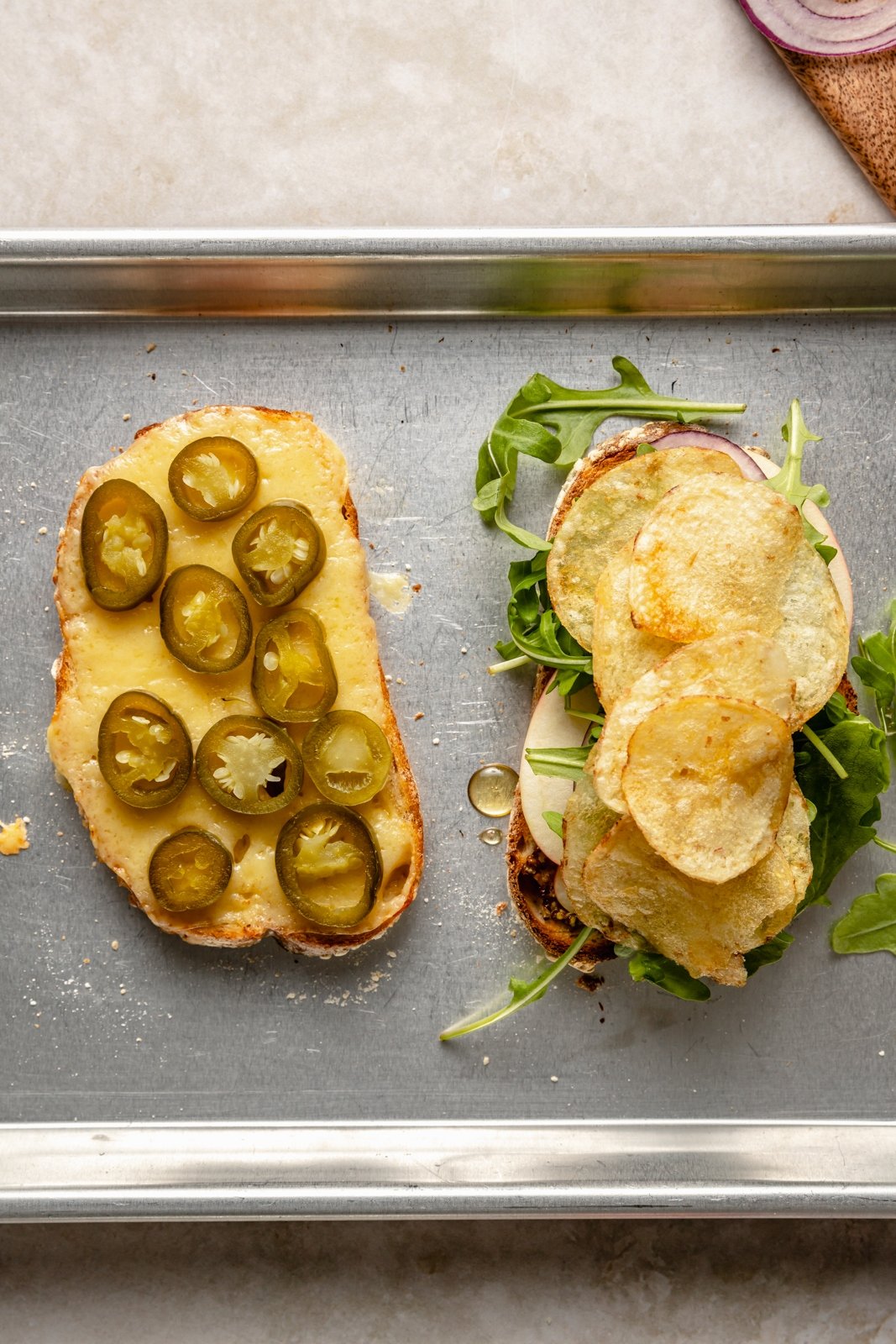 assembling an apple cheddar sandwich with chips and vegetables