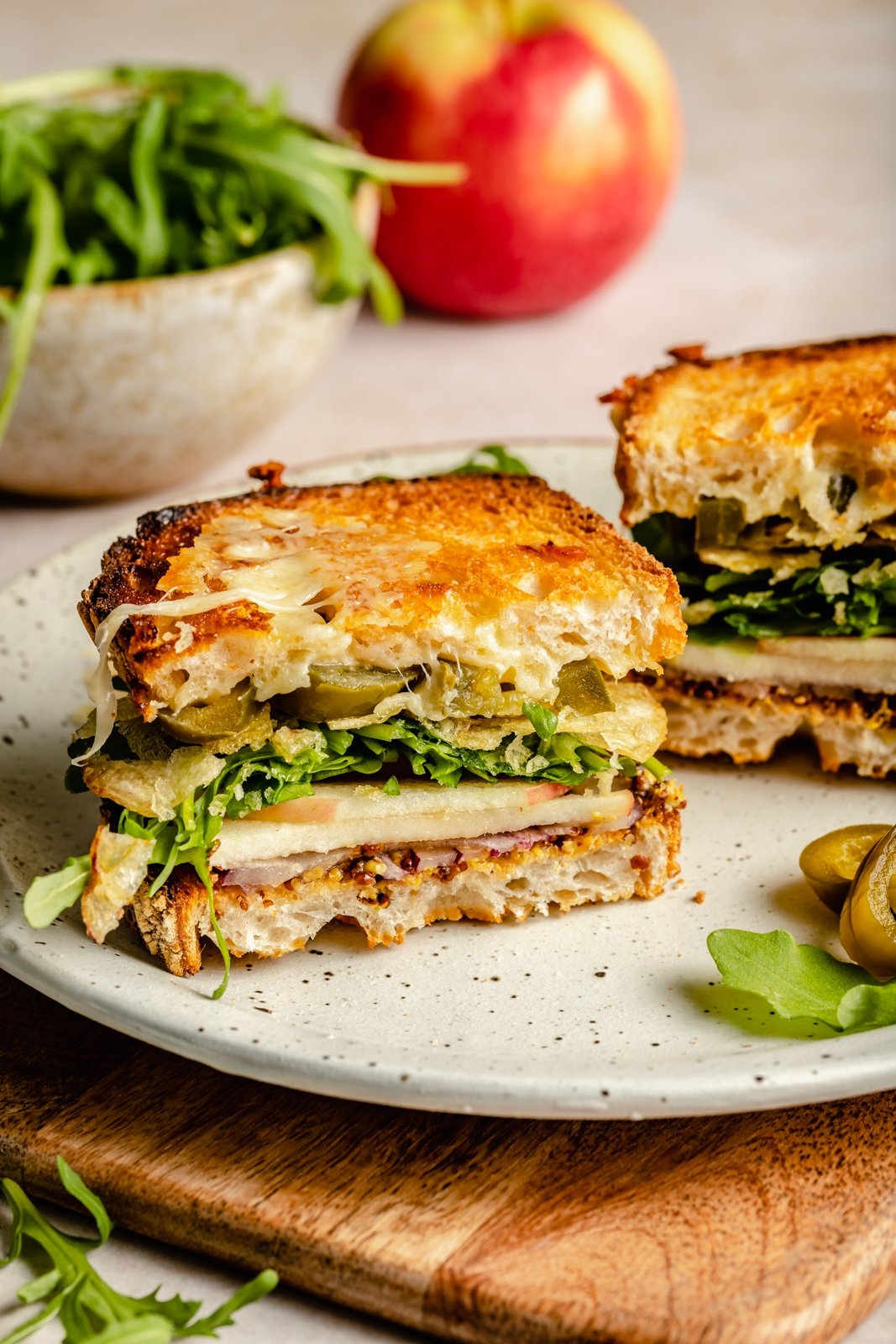 cheddar apple sandwich with veggies on a plate